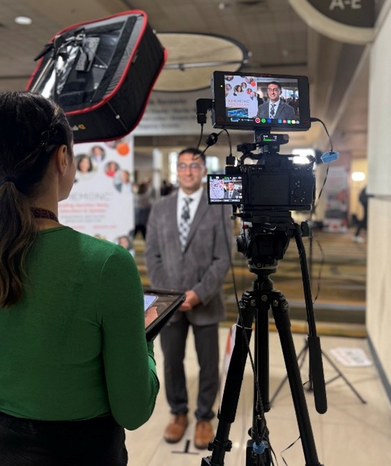 VJHemOnc Editor conducting an onsite interview with a KOL at ASH 2025